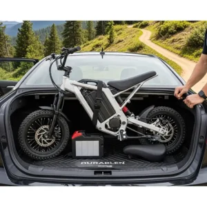 A compact electric dirt bike fitting easily into the trunk of a car, highlighting its portability and convenience.