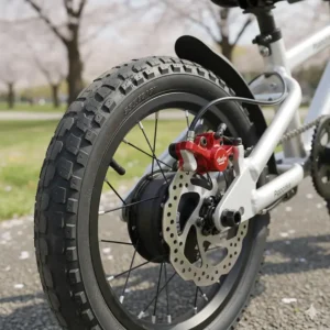 Highlighting the powerful and reliable hydraulic disc brakes on a quality toddler electric bike model.