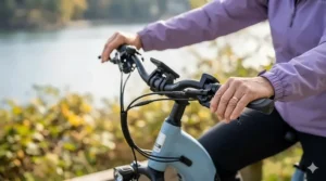 Close-up photograph of specialized ergonomic winged handlebar grips on an electric bike, designed to provide support and comfort for riders with wrist arthritis.