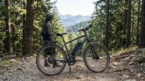 An entry-level electric mountain bike under $600 with front suspension and thick tires on a gravel trail.