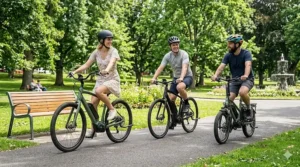 A group of friends enjoying a social ride on their electric bikes through a lush green park in summer.