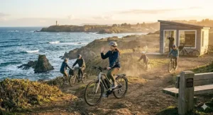A family enjoying a weekend ride on high-quality electric bikes for coastal areas near the scenic ocean shoreline.