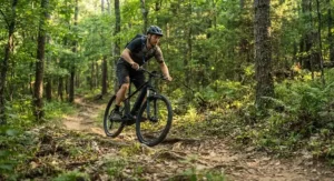 A rider navigating a scenic singletrack trail on an affordable hardtail emtb under $2000.