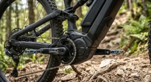 Close up of a powerful mid-drive motor and integrated down-tube battery on an electric mountain bike built for steep uphill climbs.