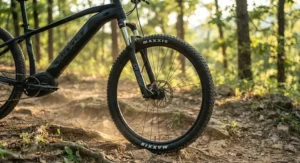 Front suspension fork absorbing bumps on a rugged trail for a hardtail emtb under $2000.