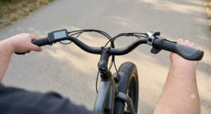 Swept-back ergonomic handlebars allowing an upright riding position on a step-through ebike for heavy riders.