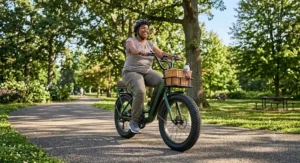 Fat tires on a step-through electric bike for plus-size riders providing stability on a sunny park path.