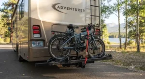 A folding electric bike securely mounted on an RV rear hitch rack