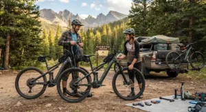 Two riders preparing their full suspension emtbs under $3000 for a weekend mountain biking trip in the backcountry.