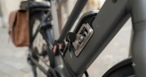 Detailed view of the secure, tamper-proof battery lock on an urban electric bike.