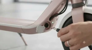 Close-up view of the battery charging port on a lightweight electric scooter for women.