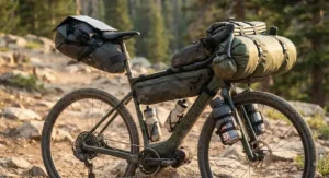 Detailed view of camping gear packed on a gravel ebike for bikepacking trips.