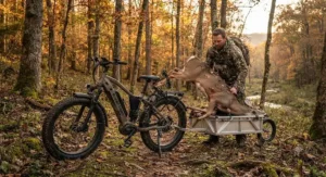 A bowhunter using an electric hunting bike under $2000 to transport harvested game out of the timber.