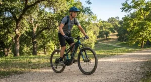 A novice cyclist learning proper balance and posture on a trail eMTB in a park.