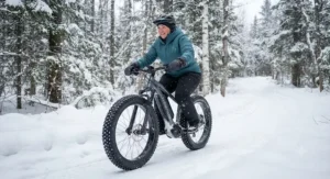 A plus-size rider navigating winter snow trails on an all-season fat tire electric mountain bike with wide grip tires.