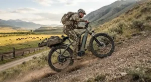 A high-torque electric hunting bike under $2000 climbing a steep dirt hill on a ranch in the American West.