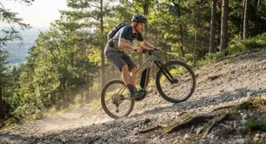 Mountain biker effortlessly climbing a steep, rugged gravel incline using the pedal assist on a hardtail electric mountain bike.
