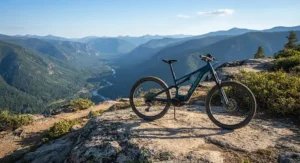 A trail eMTB parked on a mountain overlook with a scenic valley view in the background.
