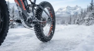 Detailed view of oversized fat tires on an eMTB gripping packed snow and ice.