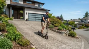 Testing dual motor electric scooter hill climbing capabilities on a steep suburban asphalt driveway.