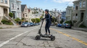 A rider demonstrating dual motor electric scooter hill climbing up a steep residential street in San Francisco.