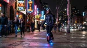 Rider cruising on the fastest electric scooter at night with bright LED headlights illuminating the pavement