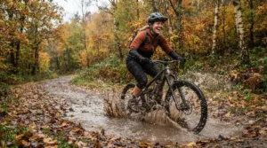 A commuter testing an off road electric scooter through a muddy park trail.