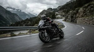 An enthusiast leaning into a mountain curve wearing a performance motorcycle riding jacket with armor for naked bike riders.
