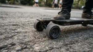 The wide stable wheels of the safest electric scooter for kids rolling smoothly on a smooth concrete patio.